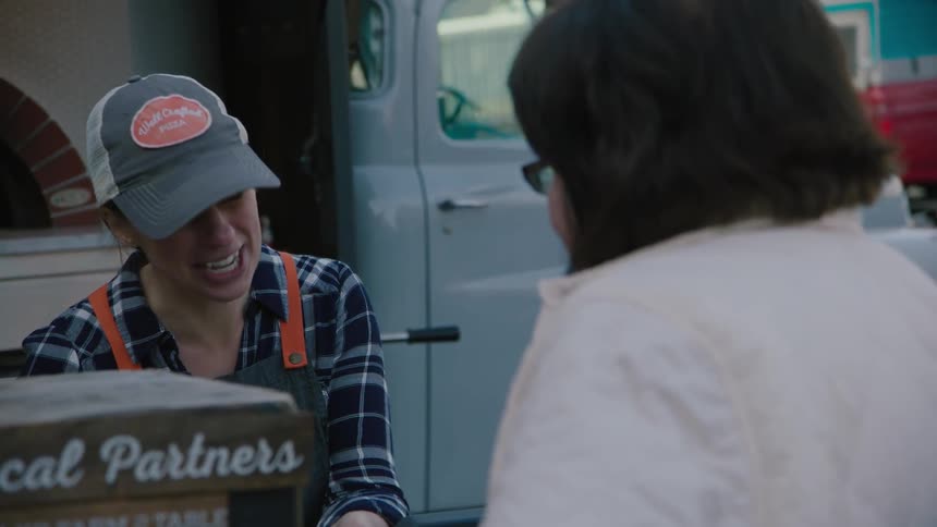 Woman talks to a food truck employee