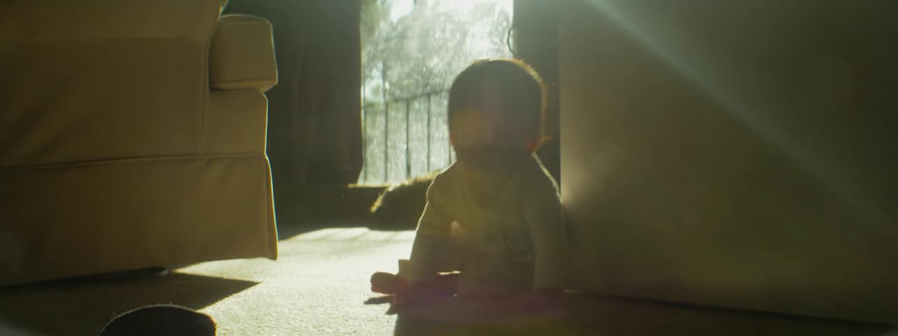 A baby is crawling through the home