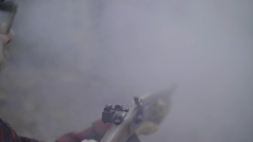 A man fires a rifle