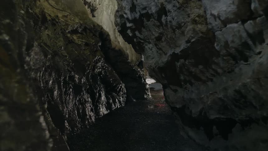 A light glows inside a rock cave