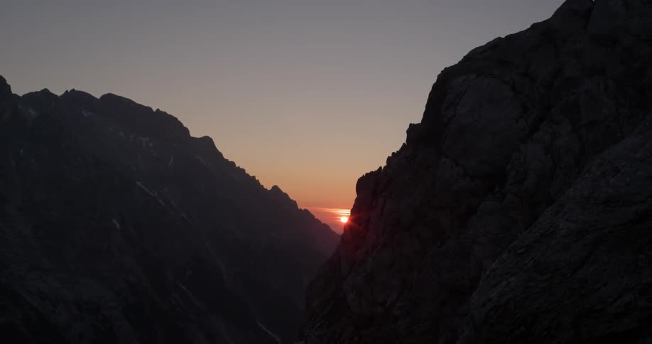 Sun setting behind mountains
