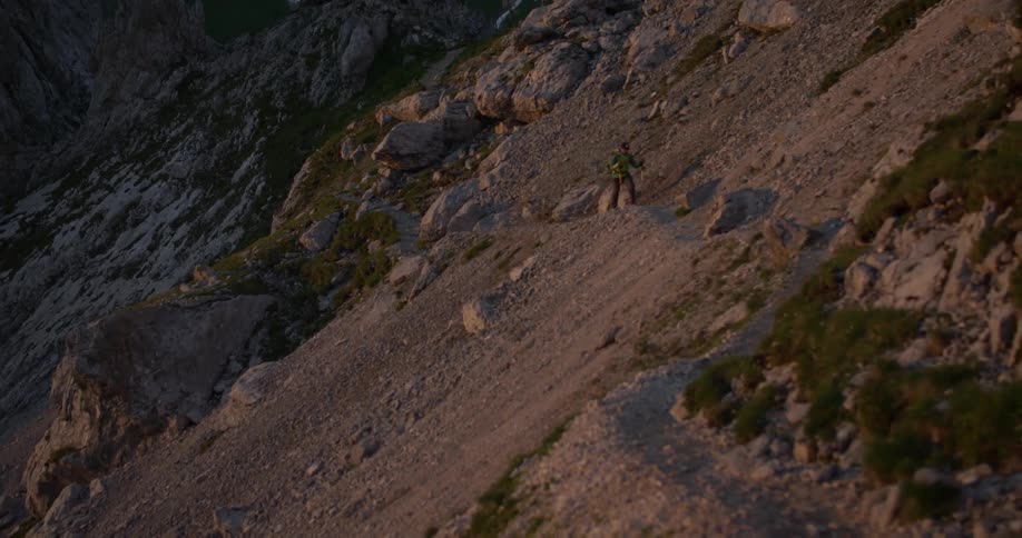 Person hiking up the side of a rocky mountain