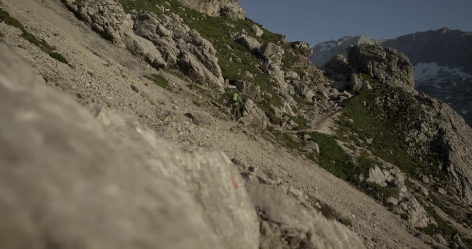 A man is hiking up the mountain