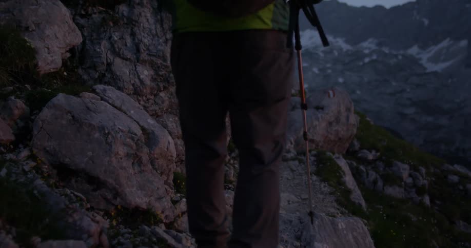 A man hikes up a hillside