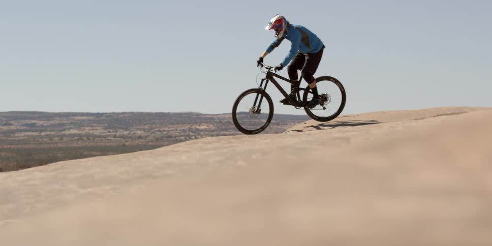 A mountain biker dives off the cliff