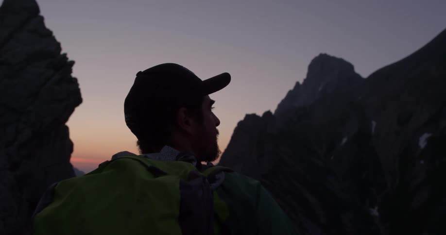 A man observes around between rock formations