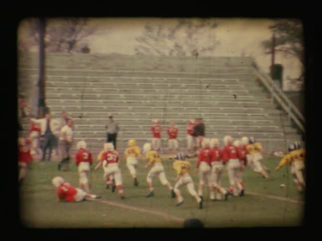 Two teams of children playing football