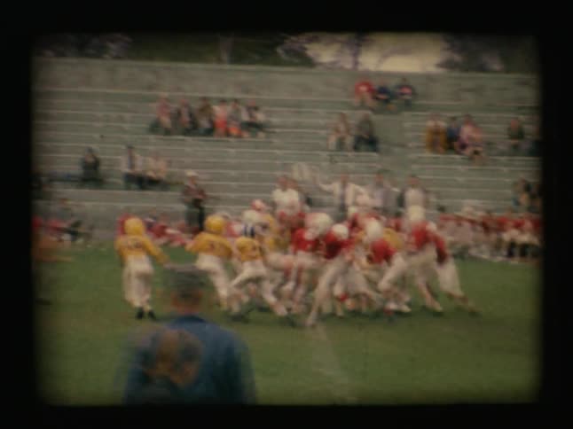 Young boys play football on a field