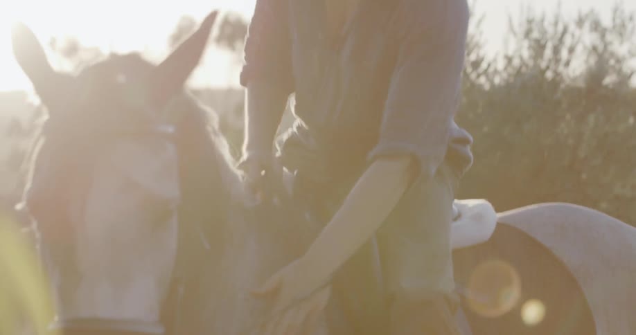 A man is riding and prompting a horse