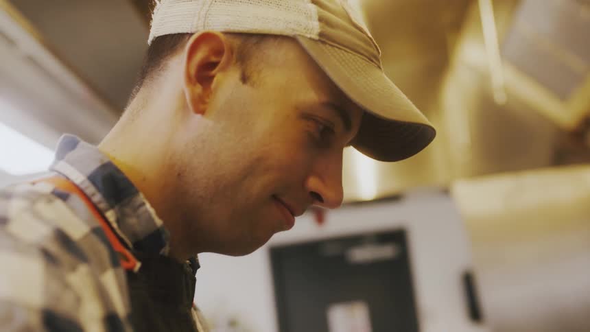 A man smiles while working