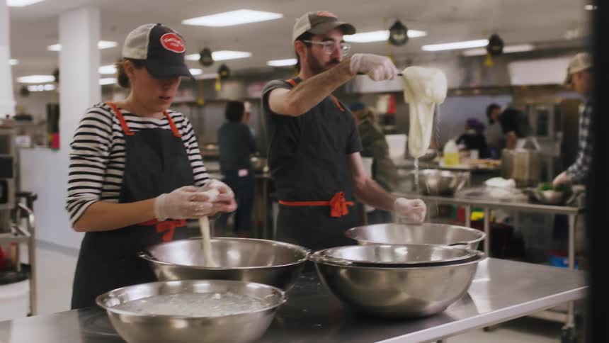 Chefs create dough in a kitchen