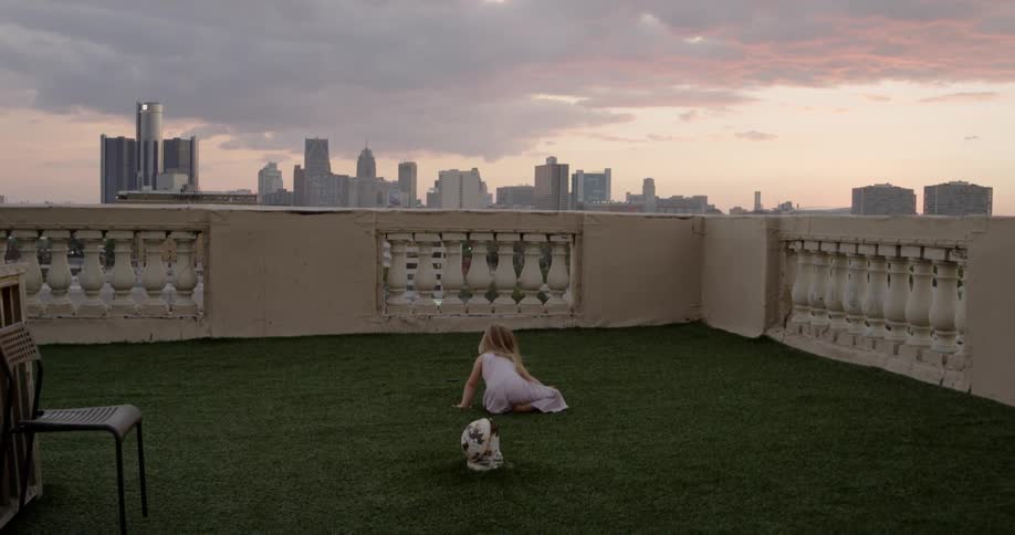 A child is playing on a rooftop