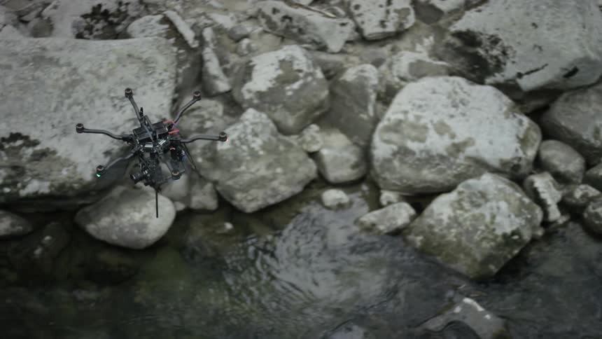 A drone flying over a stream