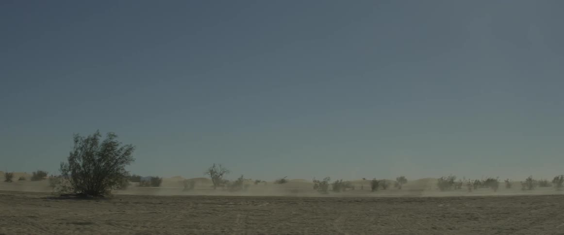 A rally car drives through the desert