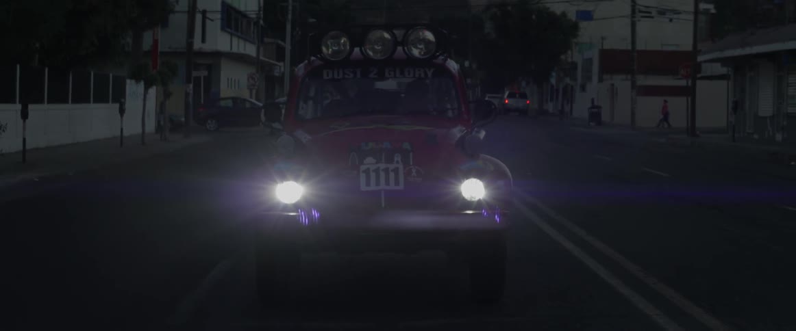 A car slowly pulling to a stop at night