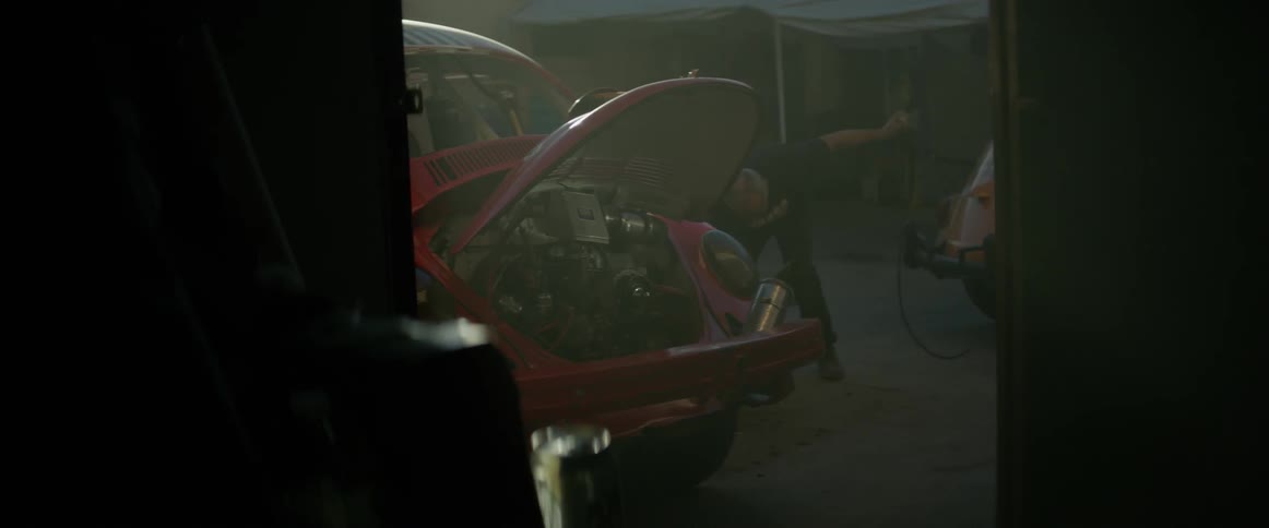 A man works on a volkswagen rally car