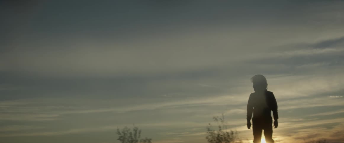 Person wearing a helmet looks at the sky