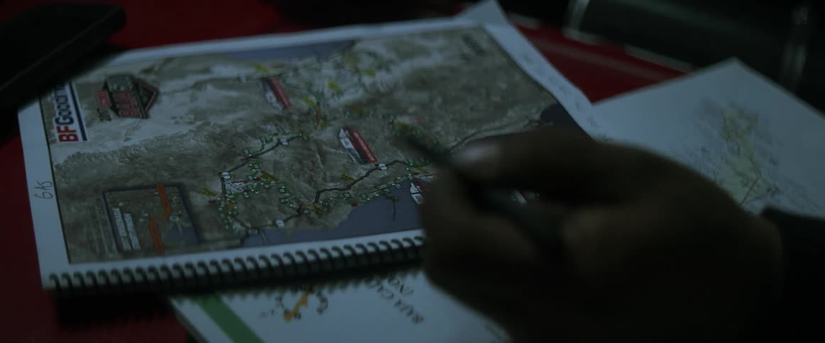 Men plot out and point to points on a map
