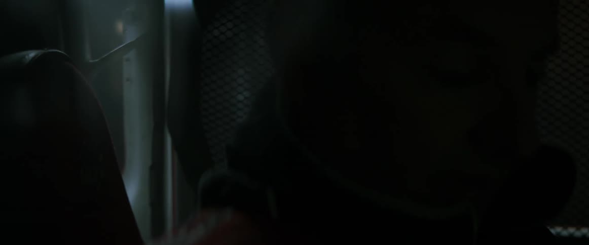 A race driver is sitting in a race car during the day