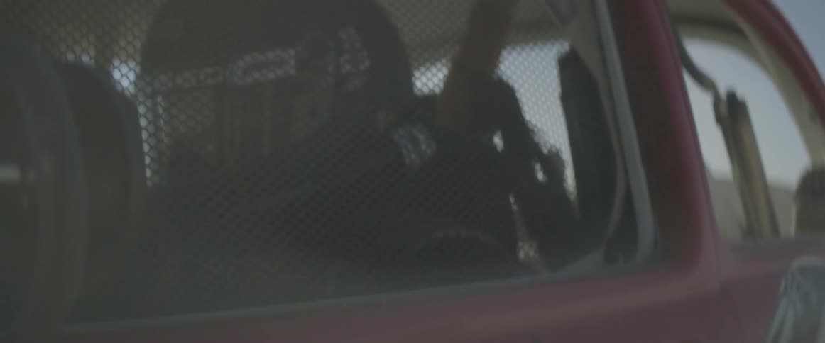 A man drives a rally car through the desert