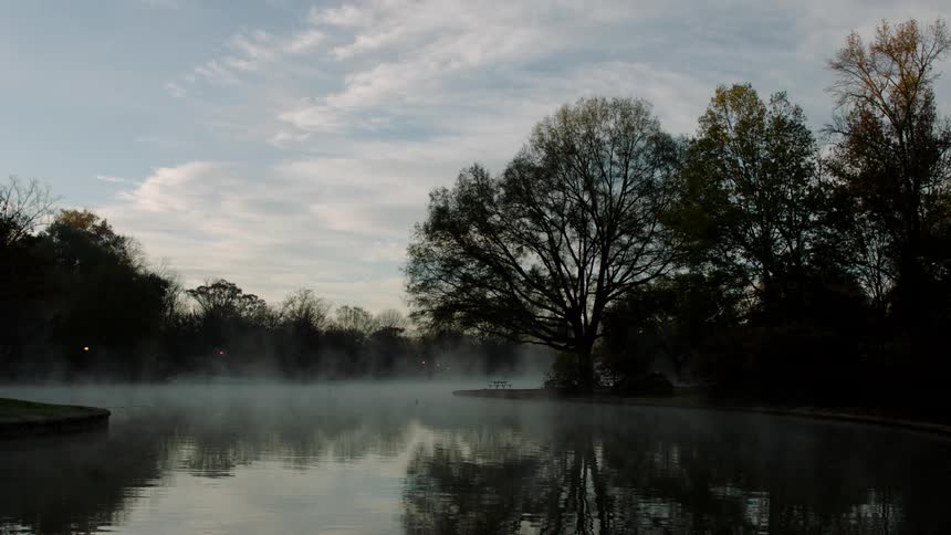 Fog rises off of a lake