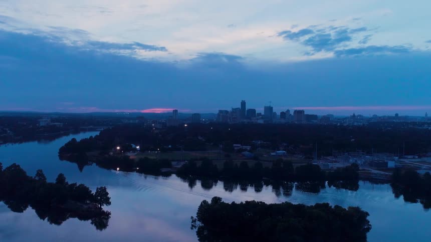 A cityscape is shown at sunset