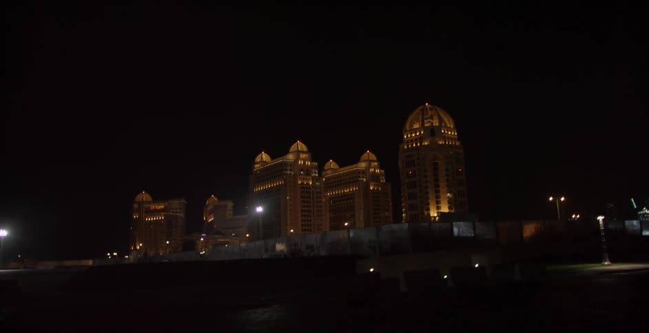 Colored lights illuminate city buildings at night