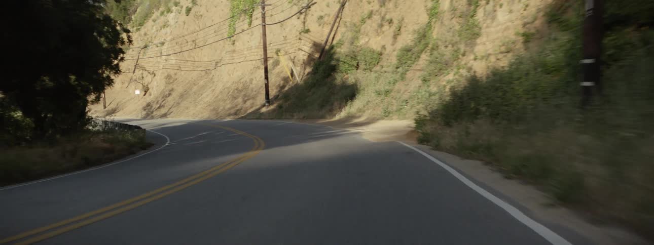 Moving view of a curvy paved country road