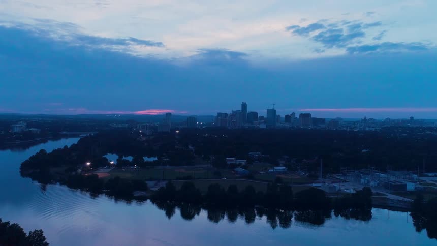 A cityscape is shown at sunset