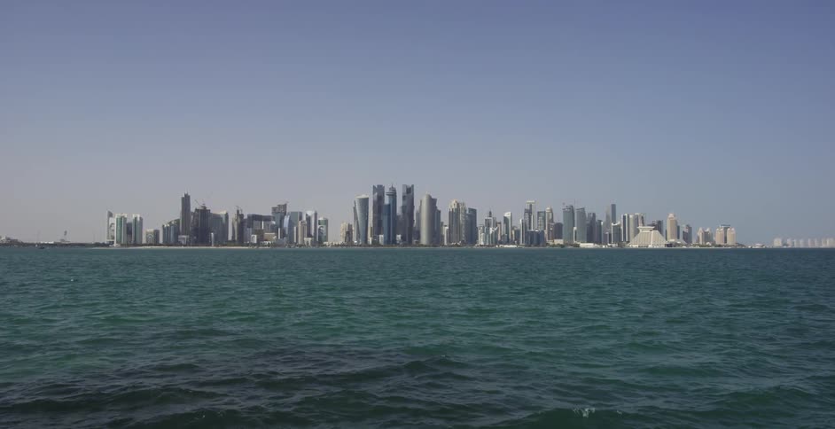 Ocean water ripples and flows in front of skyscrapers