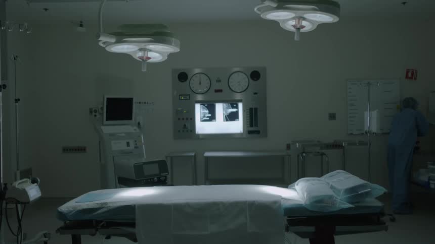 Doctors prepare for surgery in a hospital room