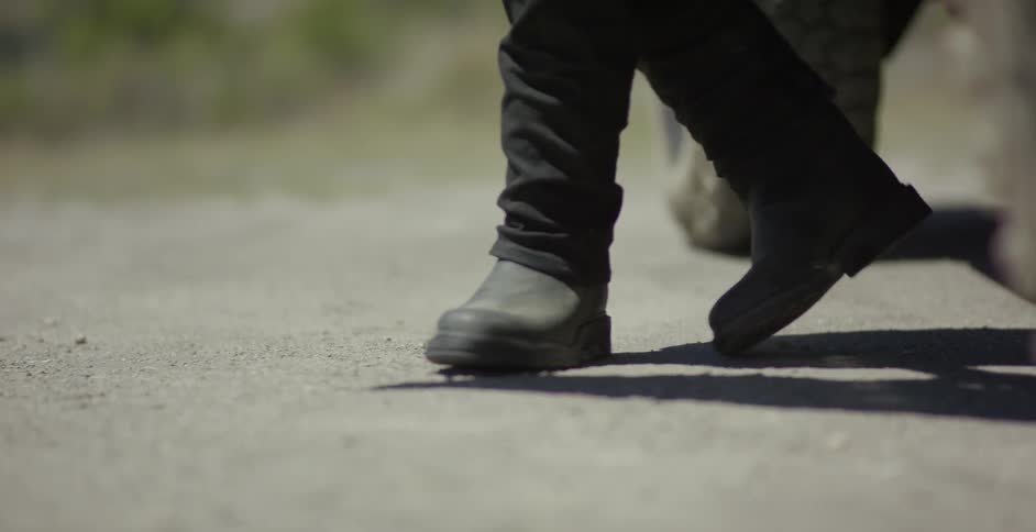 Person wearing black boots climbs out of a vehicle