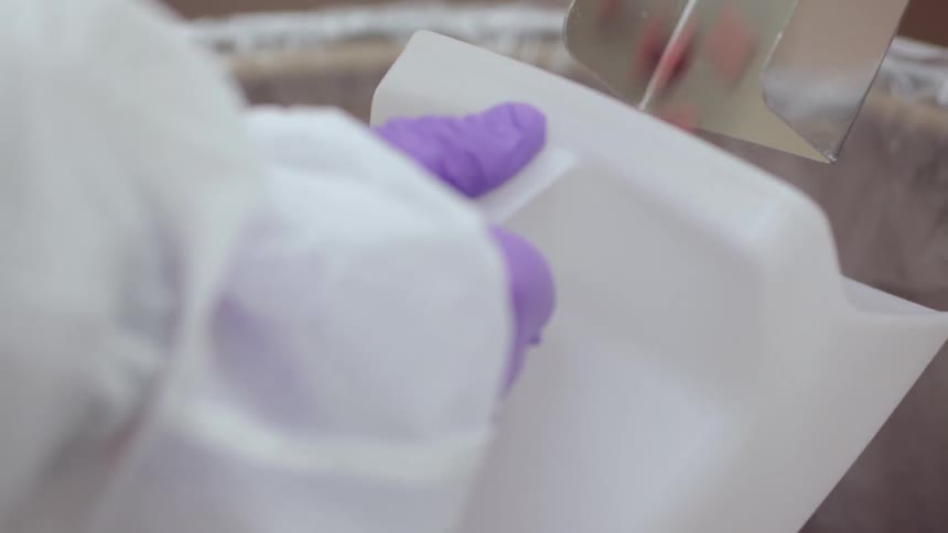 Pills falls down a chute into a plastic container