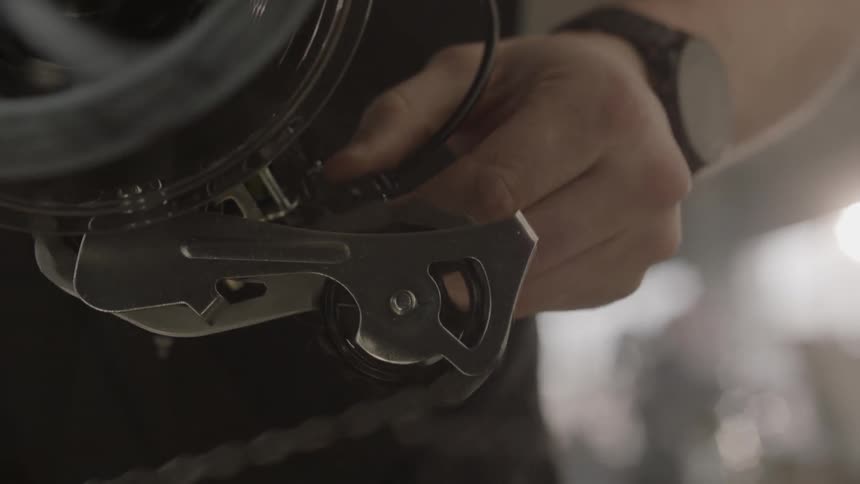 A man spins a bicycle tire