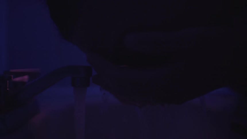 Close up of person splashing water on their face