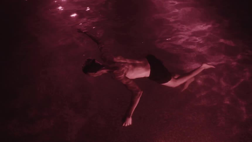 Person floats face down in water as if dead