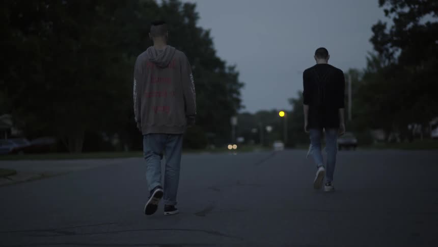 Two teenagers walking down the street on a cloudy day