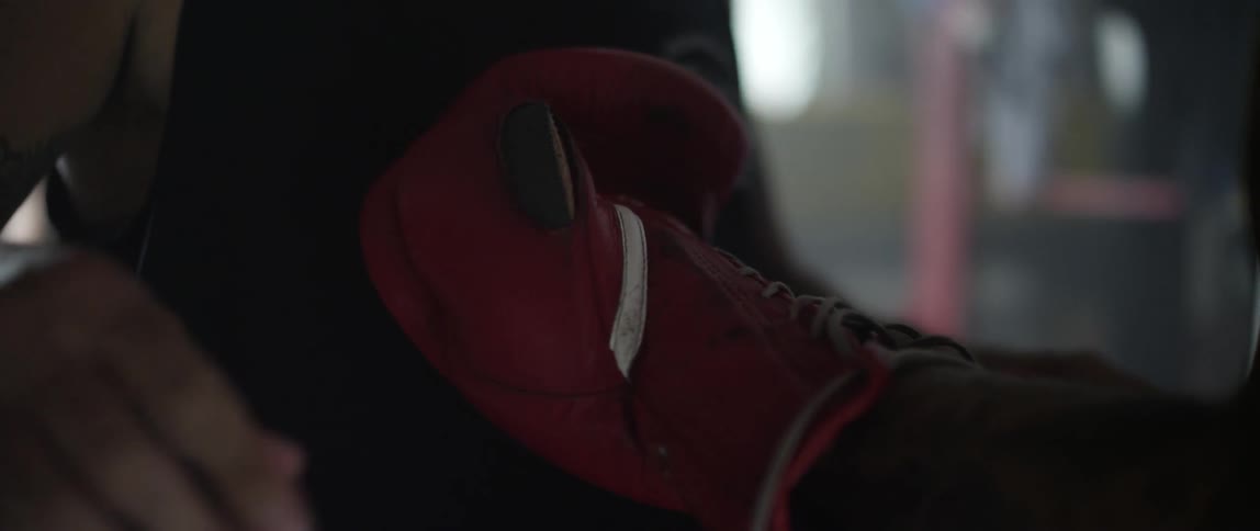 Close up of hands tying a boxing glove