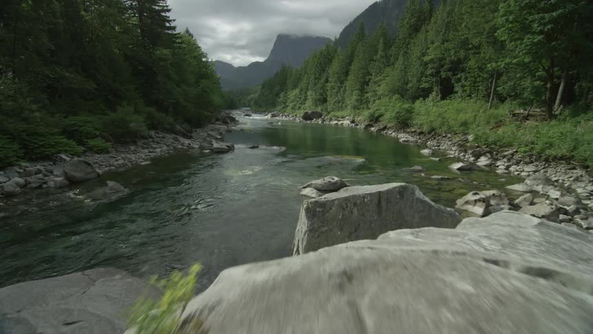View of a large rock in some rapids
