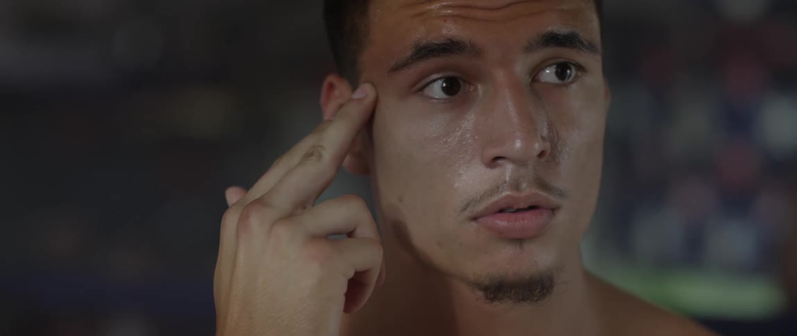 A man rubs his temples with his fingers