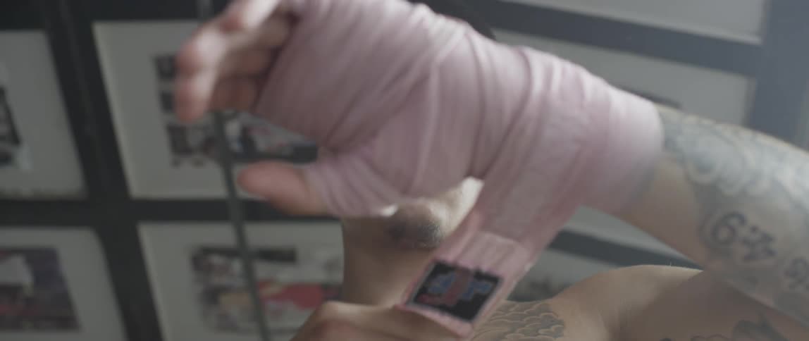 Man looking down and wrapping his hand