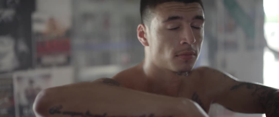 A boxer stands in a boxing ring