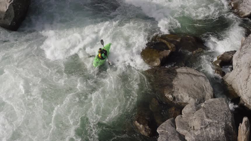 Man rowing down a fast moving rapid