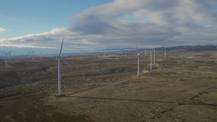 Wind turbines working on a large wind farm under a dramatic sky