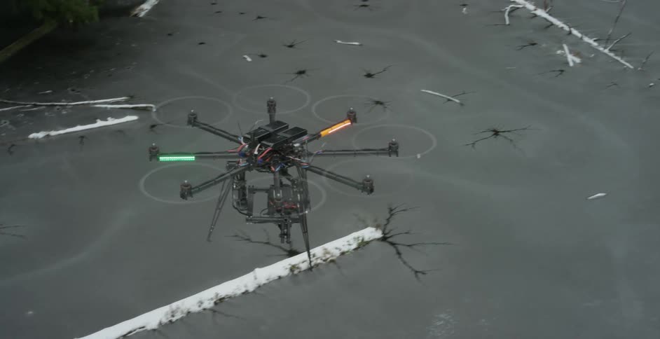 A drone flies over a frozen river filled with fallen trees and branches