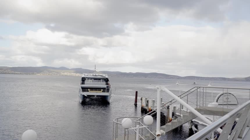 A large boat pulls into a dock