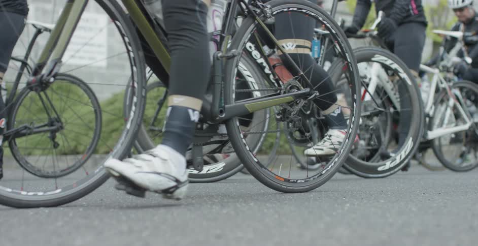 A group of cyclists are pushing off
