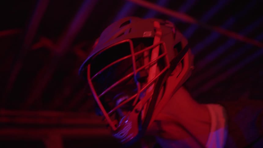 A player in a helmet slowly moves forward