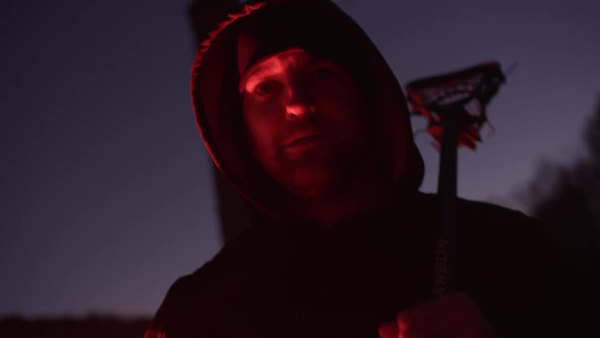 Man waves a red flare around at night