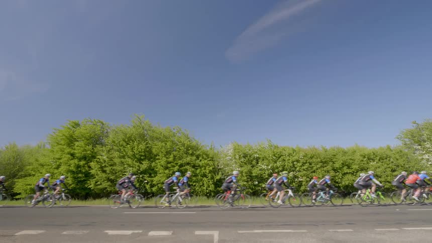 Bicyclists ride on a sunny day